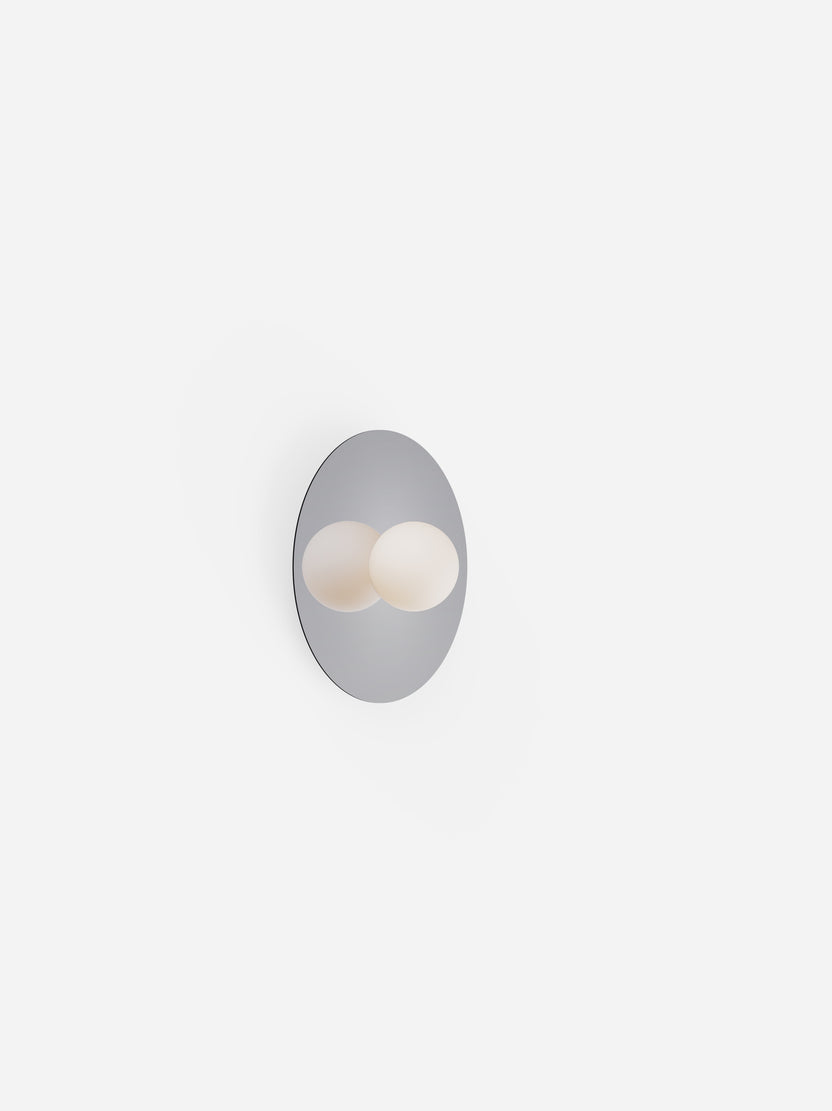 Wall-mounted light fixture with two spherical bulbs on a white background