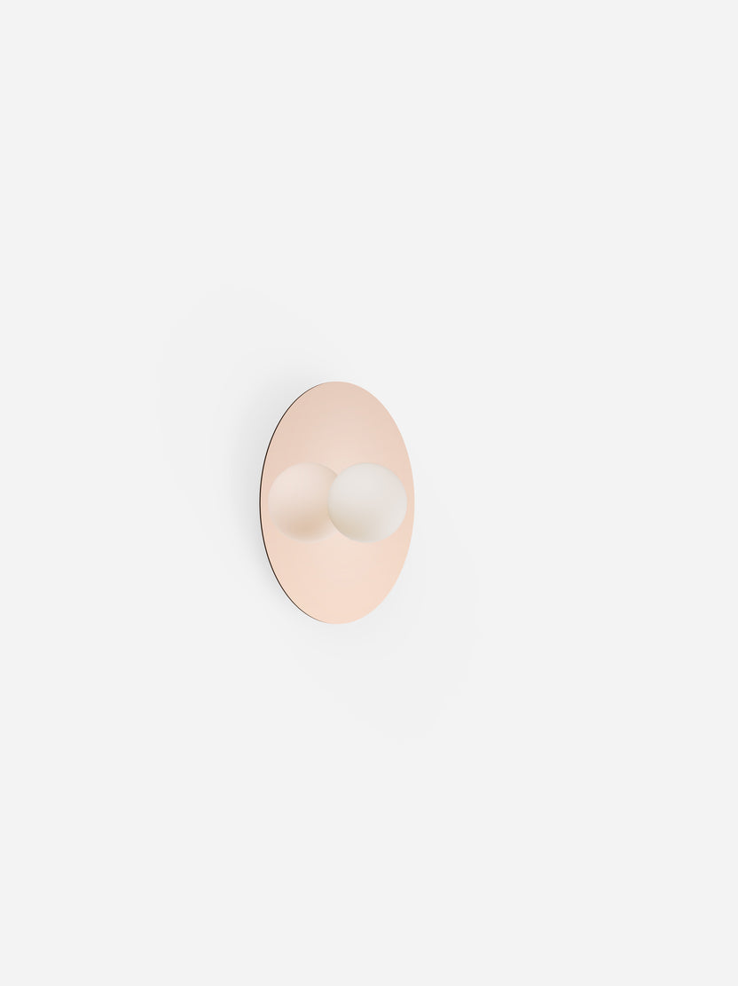 Round wall hook with a beige finish on a light gray background