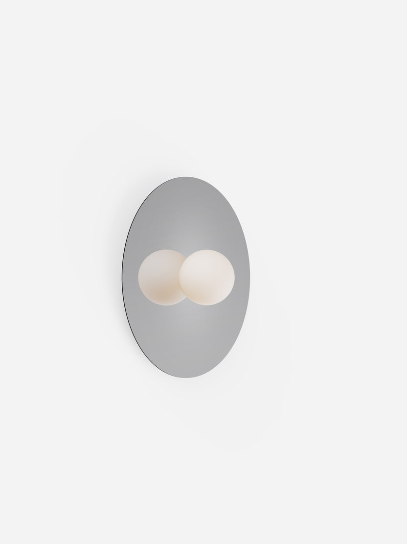 Wall-mounted light fixture with two round bulbs on a white background
