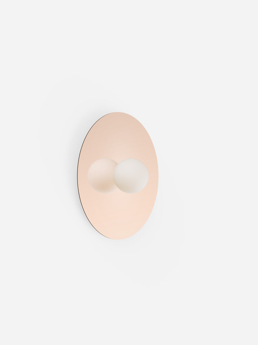 Round wall hook with a rose gold finish on a white background