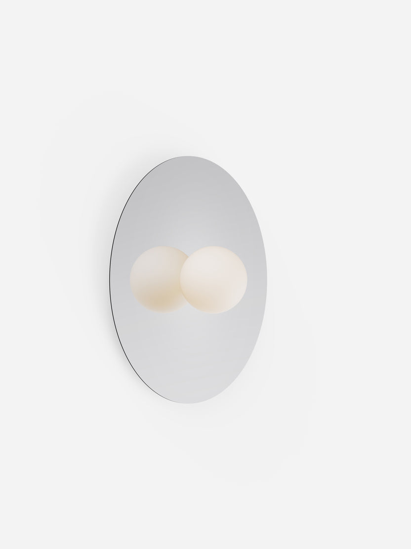 Round mirror with two light bulbs inside on a white background