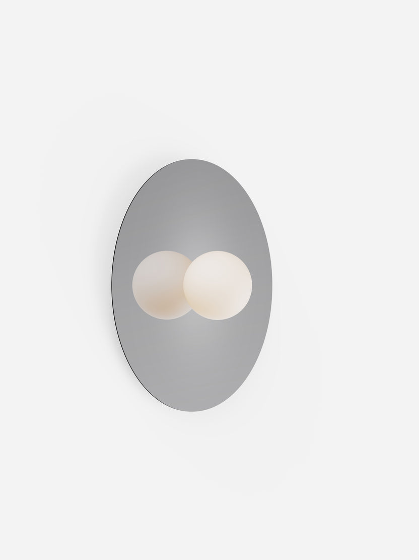 Wall-mounted light fixture with two circular lights on a white background