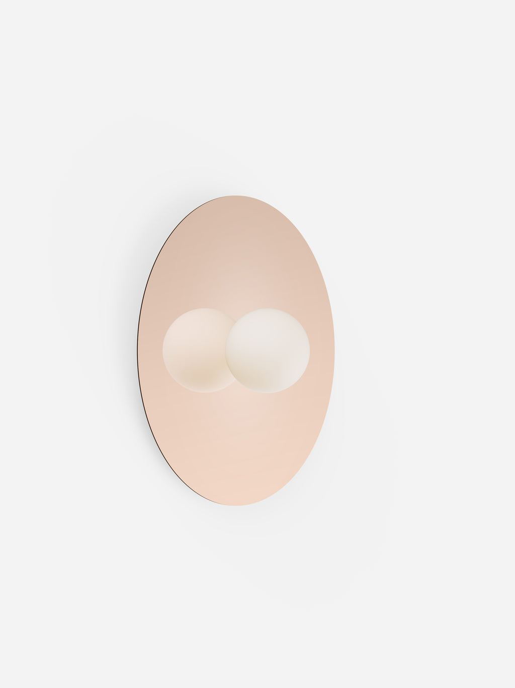 Round beige mirror with two white circular hooks on a light gray background