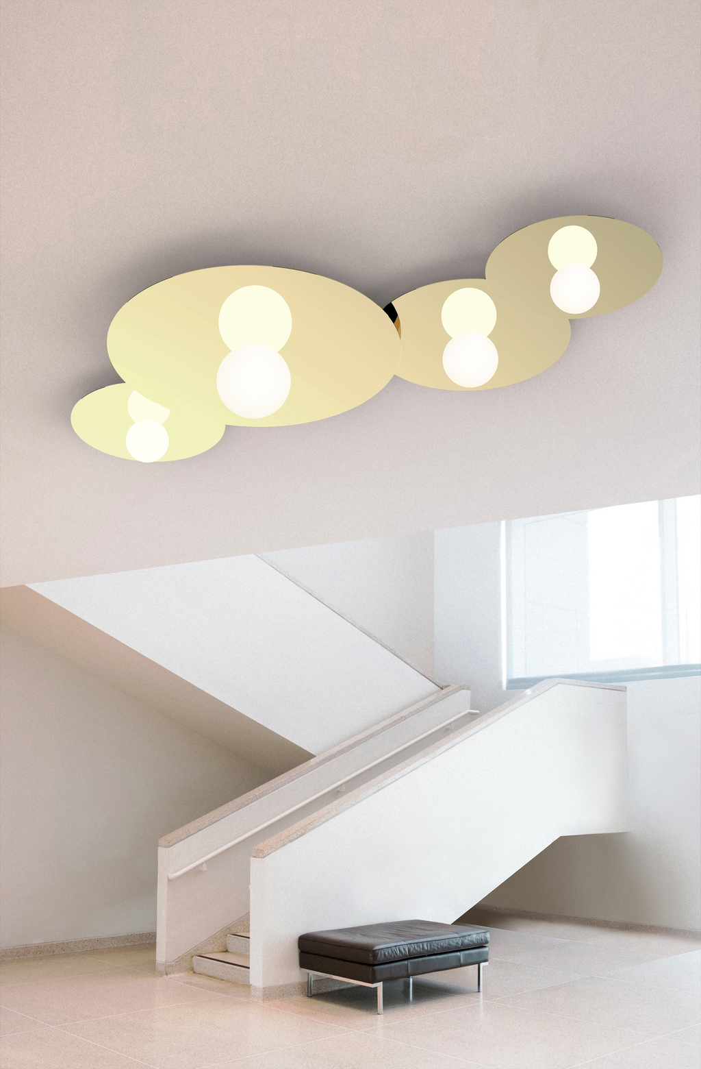 Modern ceiling light fixture in a minimalistic room with a staircase