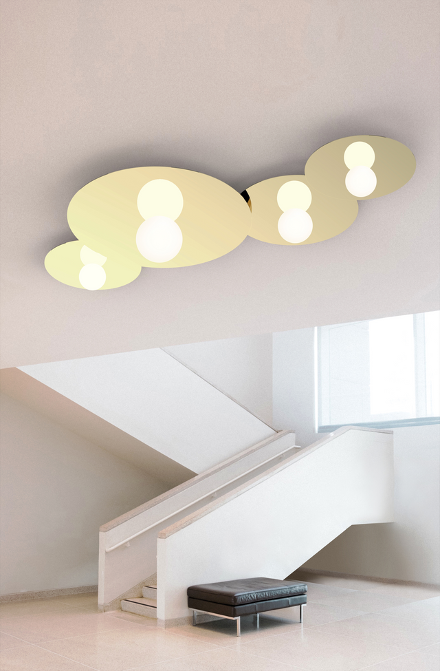 Modern ceiling light fixture in a minimalistic room with a staircase