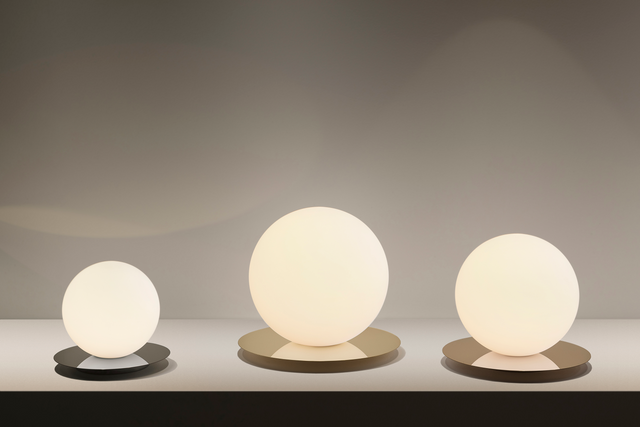 Three spherical lamps of different sizes on a neutral background