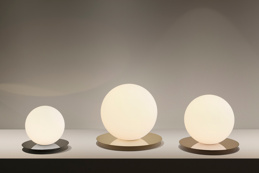Three spherical lamps of different sizes on a neutral background