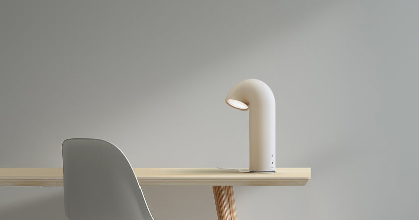White lamp on a wooden table against a gray background