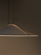 A modern pendant light with a wide, shallow conical shade made of textured white fabric, suspended by thin dark rods. The light is turned on, casting a warm glow along the bottom edge against a dark, minimalist background.